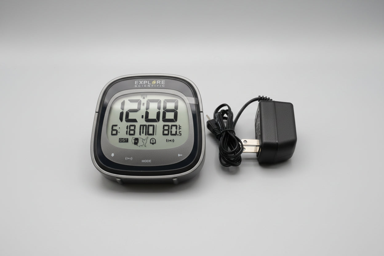 Digital clock with power adapter on a beige surface