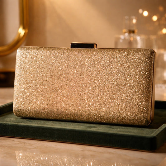 Sparkling gold clutch with gold chain attachment for a strap