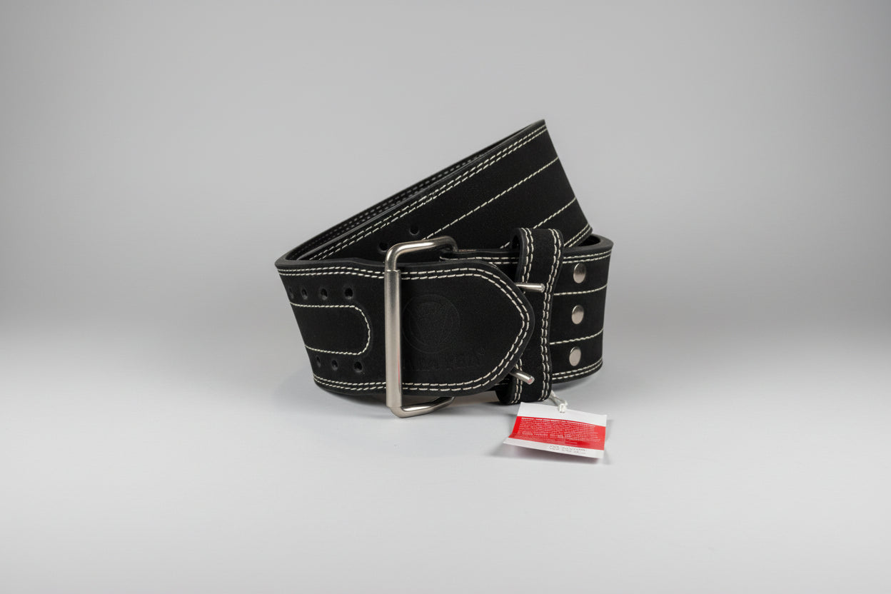 Black leather belt with silver buckle on a beige surface, accompanied by a red tag.